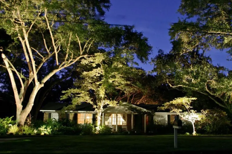 Landscape lighting illuminating a property in the evening